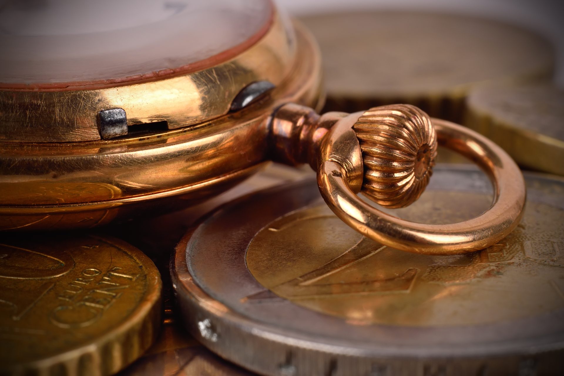 Coins and pocket watch